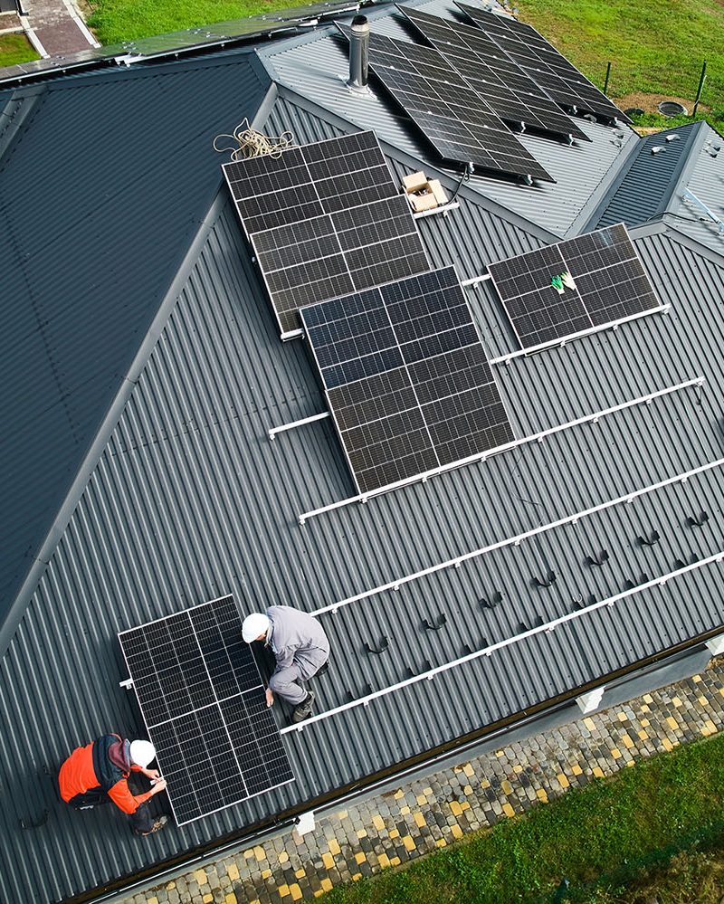 Installers installing solar panels with mounting materials - Allimex Green Power